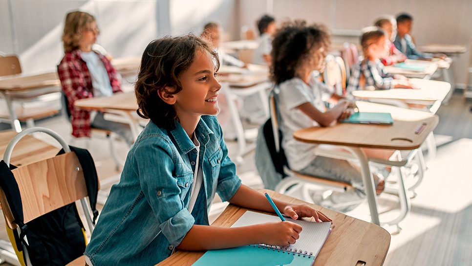 Students in a classroom sitting attentively. 