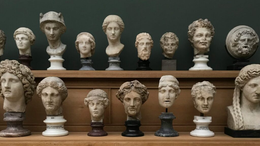 Classical busts arranged on a shelf. 